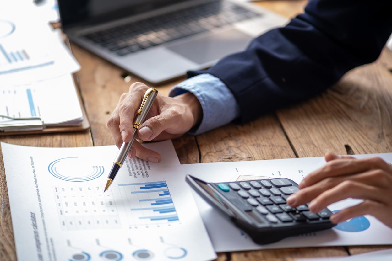 Stats on paper with someone using a calculator